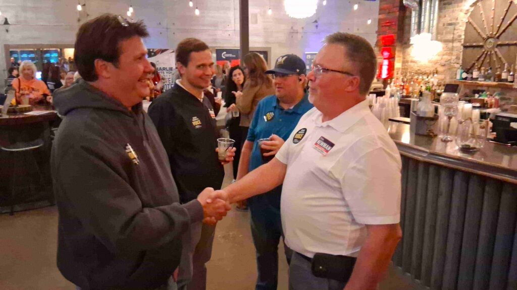Bernie Newman running for the 58th Assembly District shakes a voter's hand.